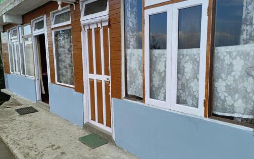 a row of windows on the side of a building at Dawaipani View Point by StayApart in Ghum