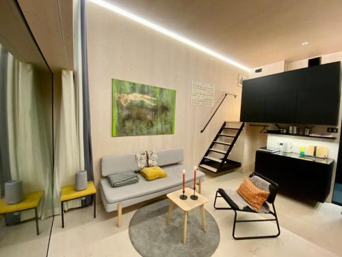 a living room with a couch and a flat screen tv at Oceanview Mini-House - Stunning Views in Ramberg