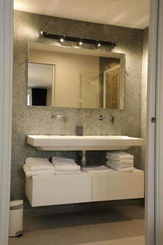 a bathroom with a sink and a mirror at Le Relais de l'Aubrac in Nasbinals