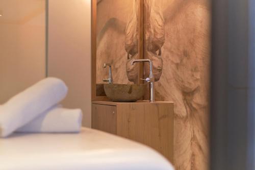 a bathroom with a sink in a room at Genuss- & Aktivhotel Sonnenburg in Riezlern