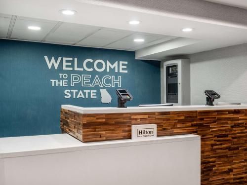 a welcome to the beach state sign on a wall at Hampton Inn Atlanta-Peachtree Corners/Norcross in Norcross