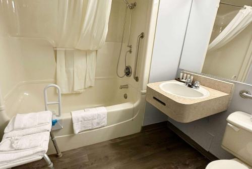 a bathroom with a sink and a toilet and a shower at Travelodge by Wyndham Welland in Welland