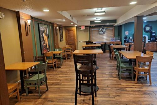 a dining room with wooden tables and chairs at AmericInn by Wyndham Vidalia in Vidalia
