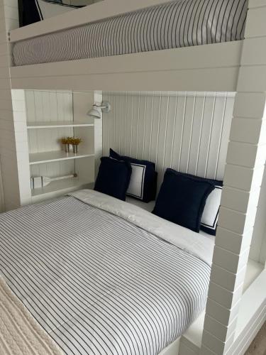 a bedroom with a large bed with blue pillows at BBA Moledo - Beachfront Apartment in Moledo
