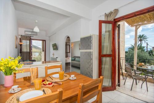 a kitchen and living room with a wooden table and a dining room at Elounda Windmills Apartment in Elounda