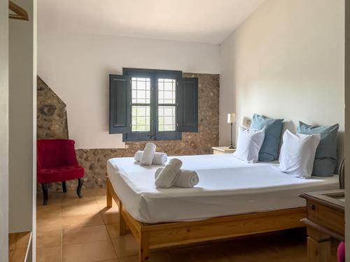 a bedroom with a large bed with towels on it at Private country house surrounded by olive trees in Crespiá