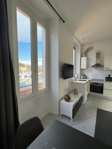 a living room with a kitchen with a view of a city at Blue Dream in Nice