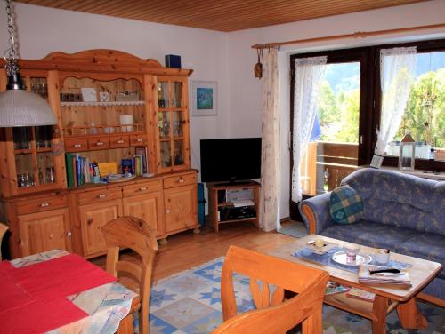 een woonkamer met een bank en een tafel bij Ferienwohnung Mattenklotz in Sachrang
