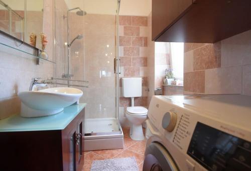 a bathroom with a sink and a washing machine at Apartman Iris -Odlično mjesto u centru Pule in Pula