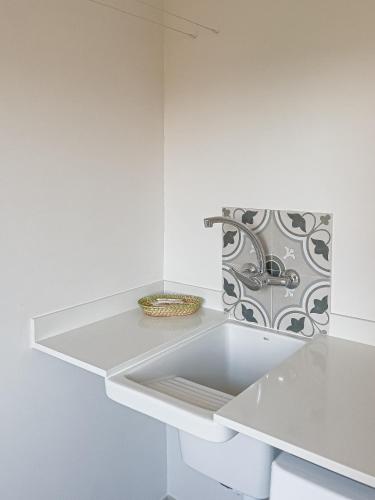 a white kitchen with a white counter and a sink at Majordoms - Ca les Cosines 47 in Banyoles