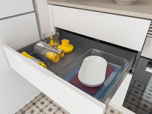a kitchen sink with a white chair in it at Majordoms - Ca les Cosines 47 in Banyoles