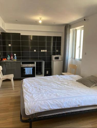 um quarto com uma cama grande e uma cozinha em Studi 400 Vieux Port Opéra em Marselha