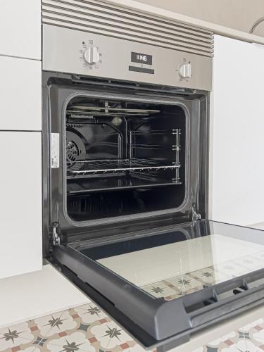 an oven with its door open in a kitchen at Majordoms - Ca les Cosines 47 in Banyoles