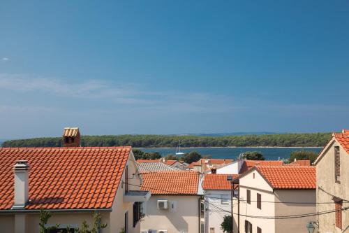 a view of roofs of houses and a river at Apartments Gabi in Punat