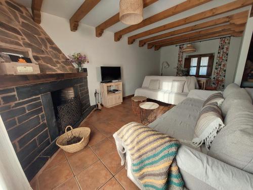 a living room with a couch and a fireplace at El Descanso de Las Hurdes 