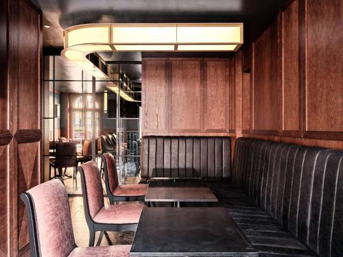 a dining room with a table and chairs at The Crown Krakow Center - Handwritten Collection ACCOR in Kraków