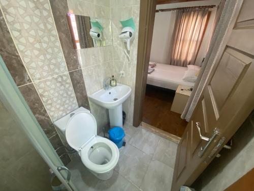 a small bathroom with a toilet and a sink at PORT APART in Antalya