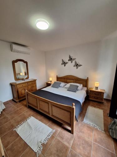 a bedroom with a large bed and a mirror at Apartmani Tara Medulin in Medulin
