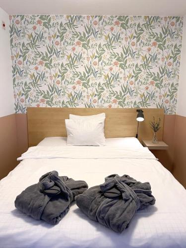 a bed with two towels on top of it at 2Home Hotel Apartments in Solna