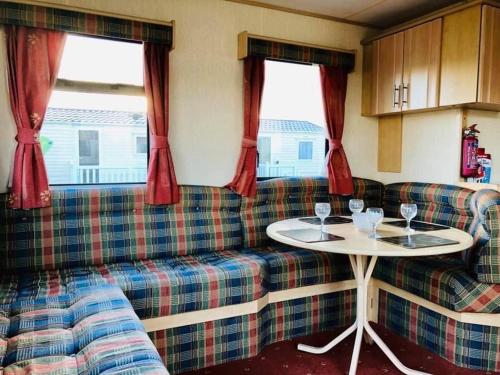 a living room with a couch and a table at MDL Holiday Let in Rhyl