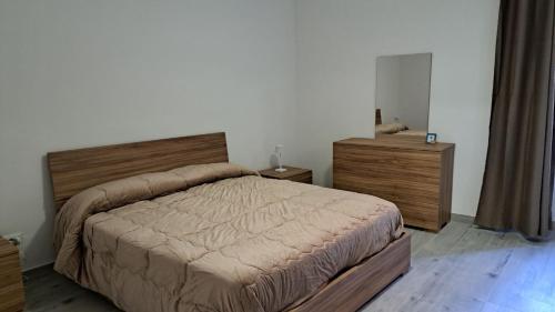 a bedroom with a large bed and two dressers at La Piazzetta in Tivoli