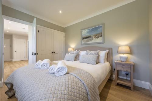 a bedroom with a bed with towels on it at Larks Rise in Burnham Market