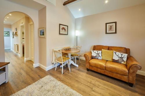a living room with a couch and a table at Host & Stay - Gas Light Cottage in Ripon