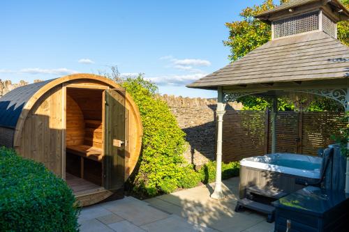 a wooden gazebo and a hot tub in a garden at Homewood Hotel & Spa - Small Luxury Hotels of the World in Bath