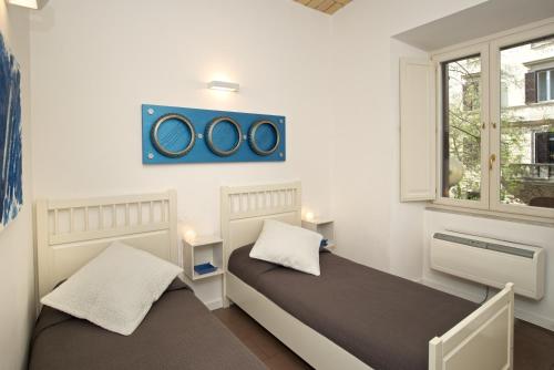 2 camas en una habitación pequeña con ventana en Germanico Maxi, en Roma