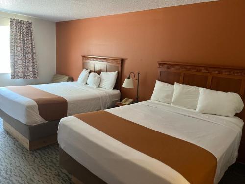 a hotel room with two beds and a window at Regency Inn & Suites in Anoka