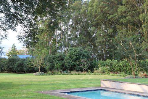 a swimming pool in the middle of a yard at Idavold Gate House in Howick