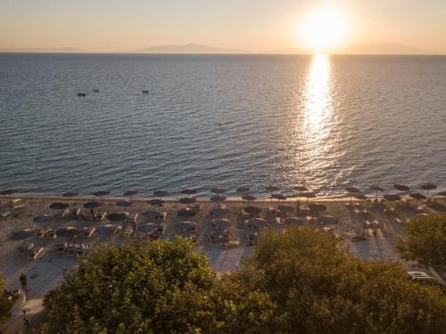 a view of a beach with umbrellas and the ocean at Alkioni By The Sea in Siviri