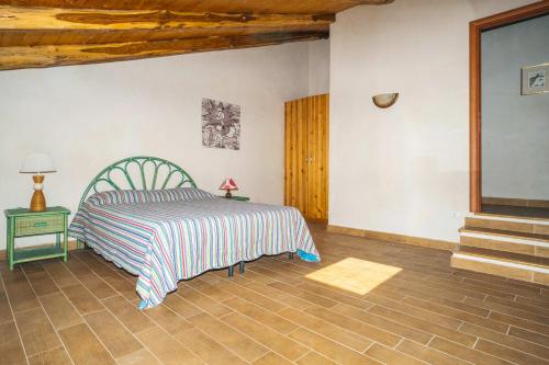 ein Schlafzimmer mit einem Bett, einem Tisch und einer Treppe in der Unterkunft Palazzo Marchesale, vista mare in Pisciotta
