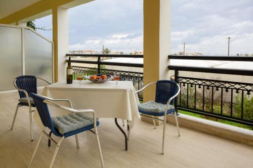 a white table and chairs on a balcony at Searocco Studios & Apartments - Close to Alykes Center, by ZanteWize in Alykes