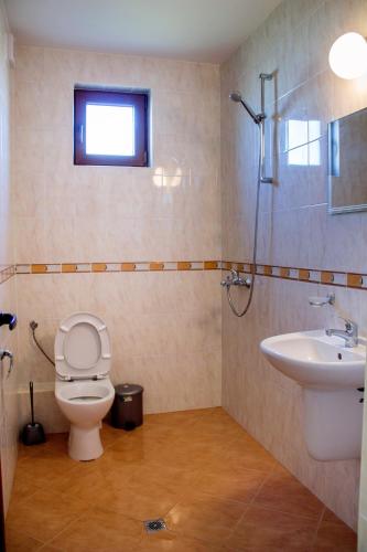 a bathroom with a toilet and a sink at Guest House Moiata Kashta in Chernomorets