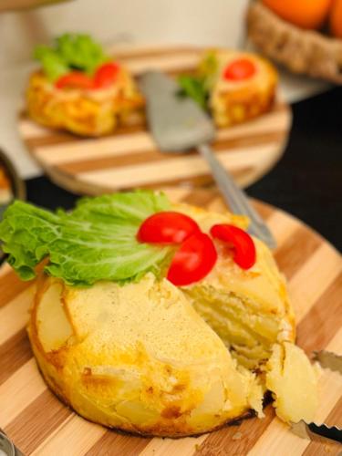 a sandwich with lettuce and tomatoes on a cutting board at Cosmopolita Boutique Hotel in Timişoara