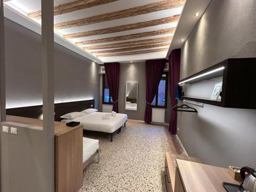 a hotel room with two beds and a tv at Ca' Piasentin in Venice