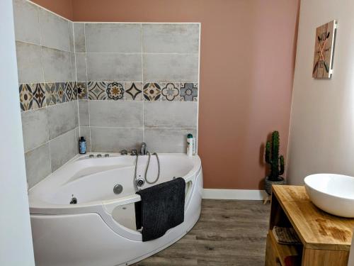 une salle de bain avec une baignoire et un lavabo dans l'établissement Appartement Cosy, au Boulou