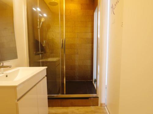 a shower with a glass door in a bathroom at Pé n' Areia by Ericeira Property in Carvoeira