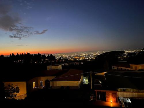 a view of a city at night at Le terrazze di Dany (attico su Roma) in Frascati