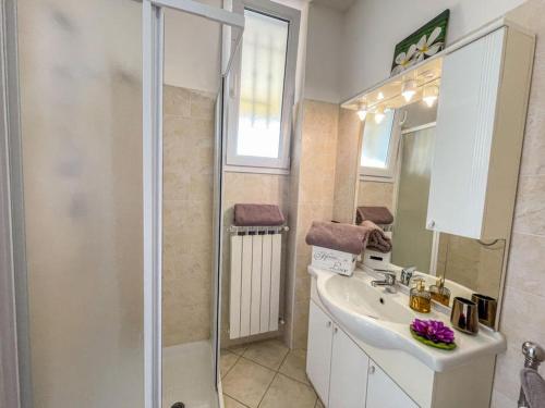 a bathroom with a shower and a sink and a mirror at Bella Vista Poggi 180Grad fantastischer Meerblick in Poggi