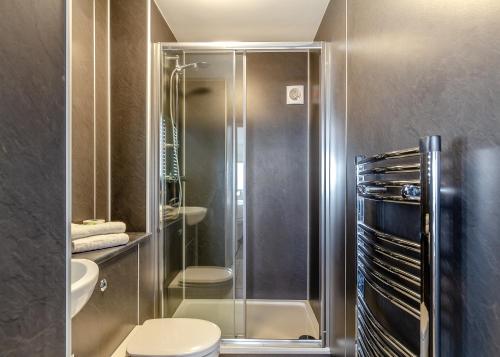 a bathroom with a shower and a toilet at Late Rooms at North Devon Resort in Ilfracombe