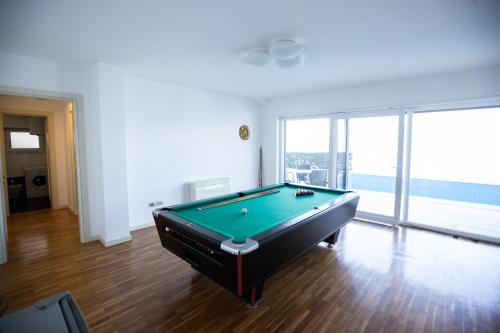 a pool table in a living room with a view at Sunset - The Twin Villa in Široka