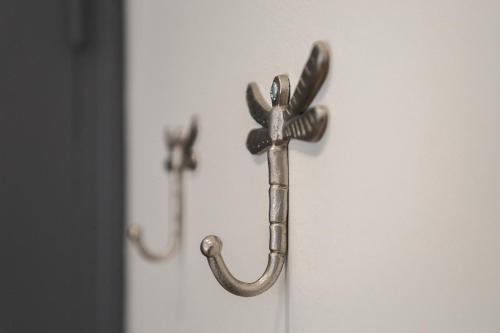 a metal door handle with a hook on a door at Centre historique vue cathédrale in Lisieux