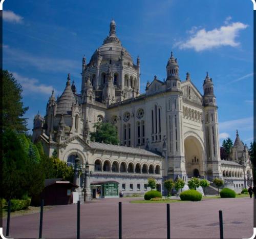 a large white building with a tower on top at Centre historique vue cathédrale in Lisieux