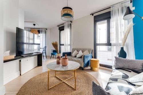 un salon avec un canapé et une table dans l'établissement Palais des congrès , 4 bedrooms, à Levallois-Perret
