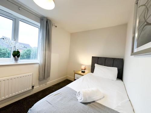 a bedroom with a white bed and a window at No.2 by Blue Skies Stays in Thornaby on Tees