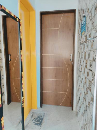 a wooden door in a room with a wall at Alu Azul 1 in Barra de São Miguel