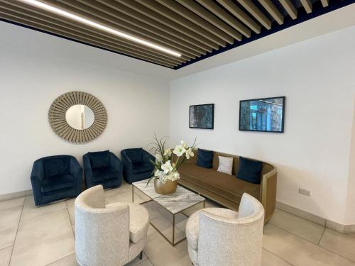 a living room with a couch and chairs at Bracknell RWH Spectacular Two Bedroom Apartment in Bracknell