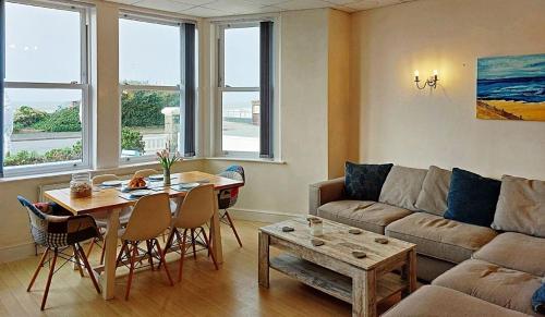 a living room with a couch and a table at Beach Front Apartment in Tywyn in Tywyn